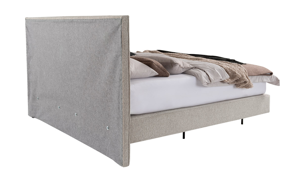 Rückenansicht von Boxspringbett mit Kissen und Decken